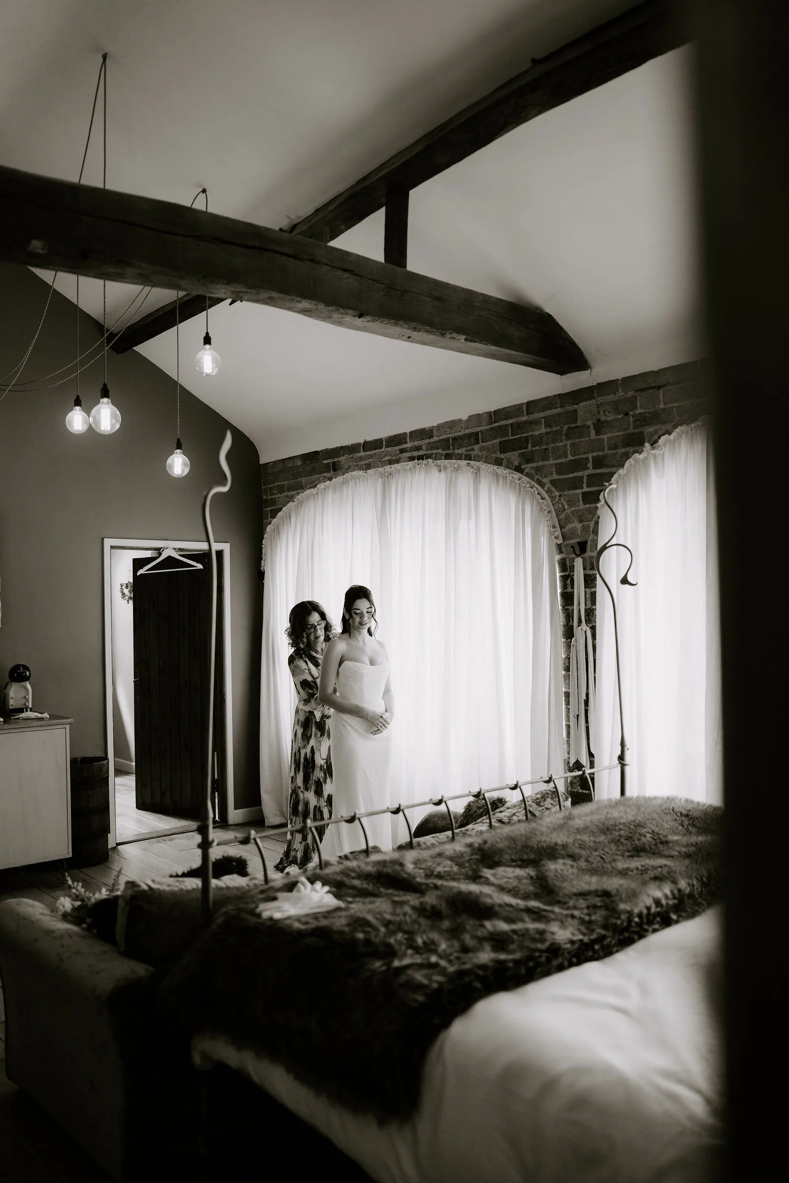 Serena and Josh exchanging vows in the Courtyard Barn at Dodmoor House