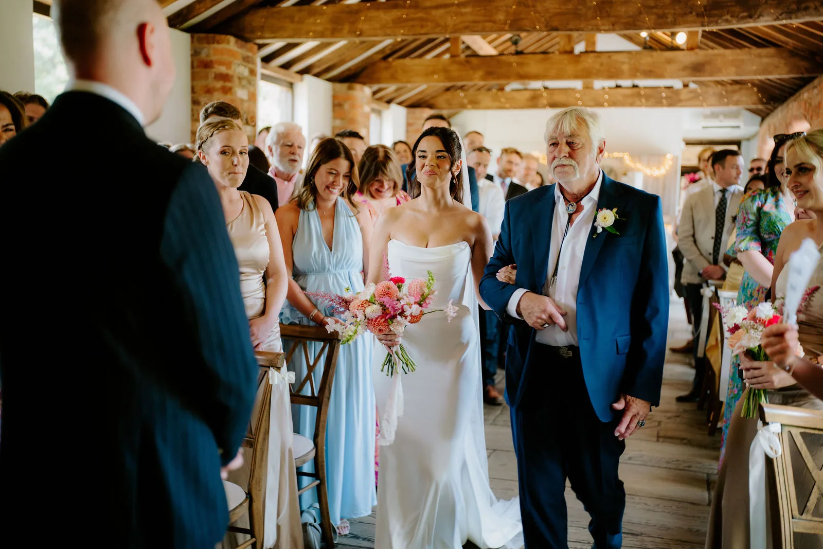 Serena and Josh showered with colourful confetti in the Dodmoor House courtyard