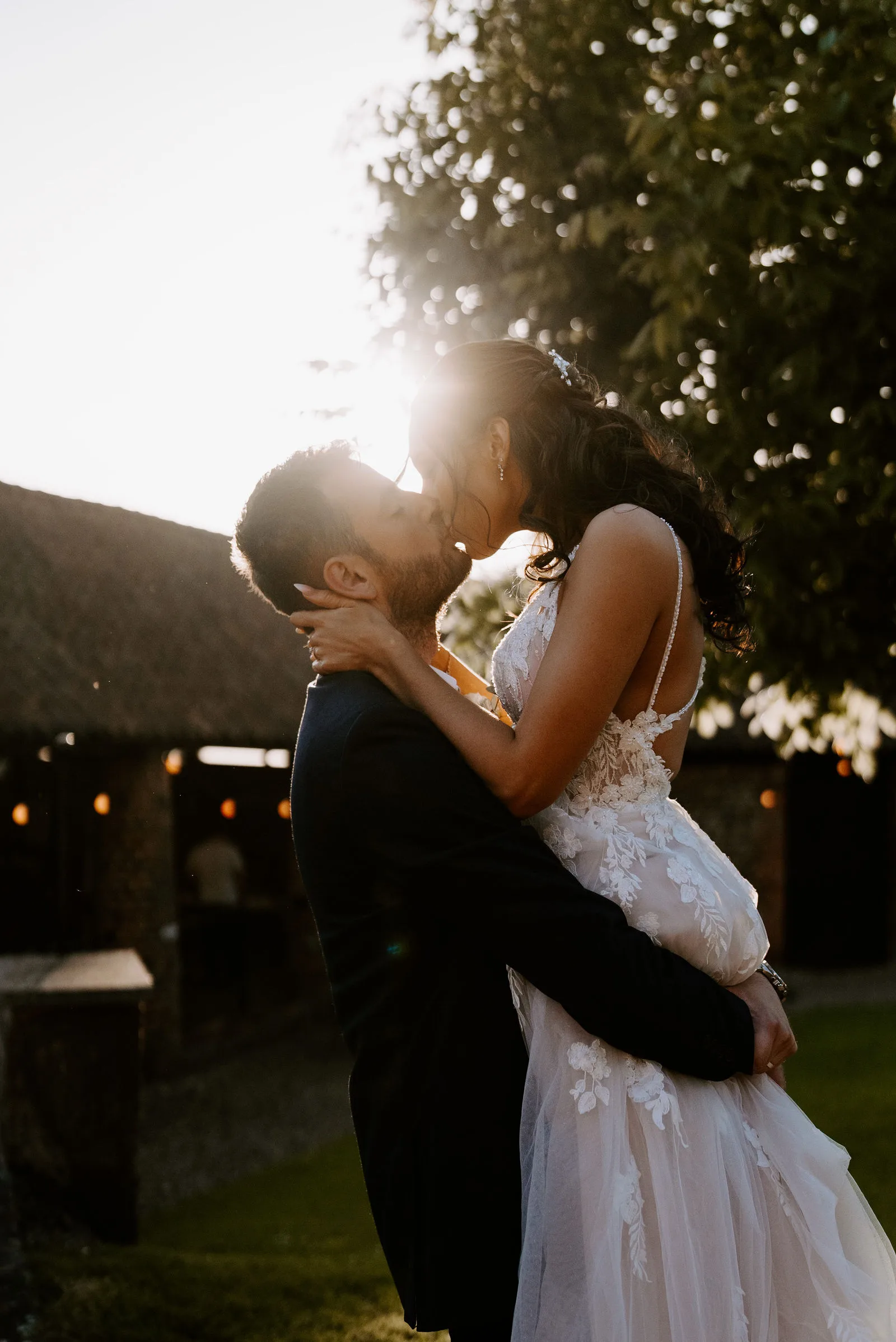 Louise and Brett embracing outside the 18th-century converted barn at Hunsbury Hill