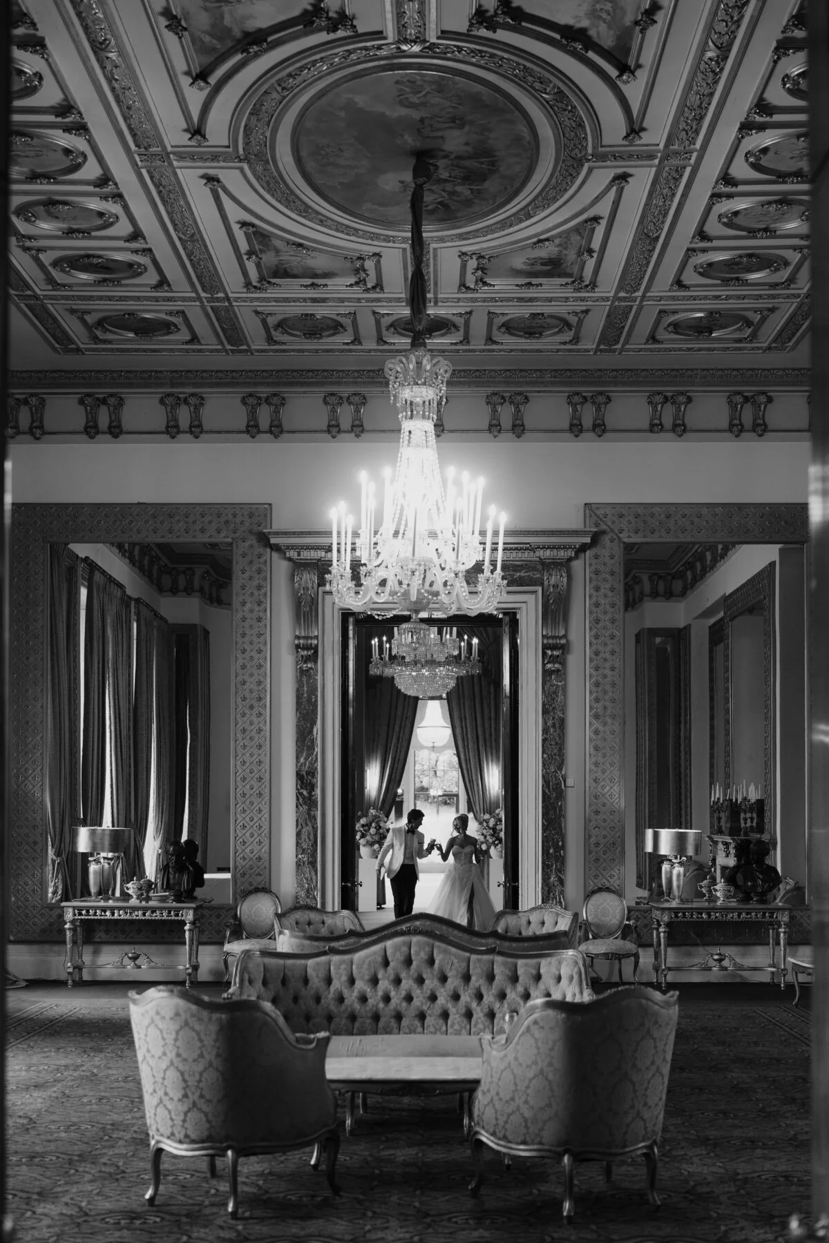 Black and white photograph of an elegant indoor wedding ceremony.