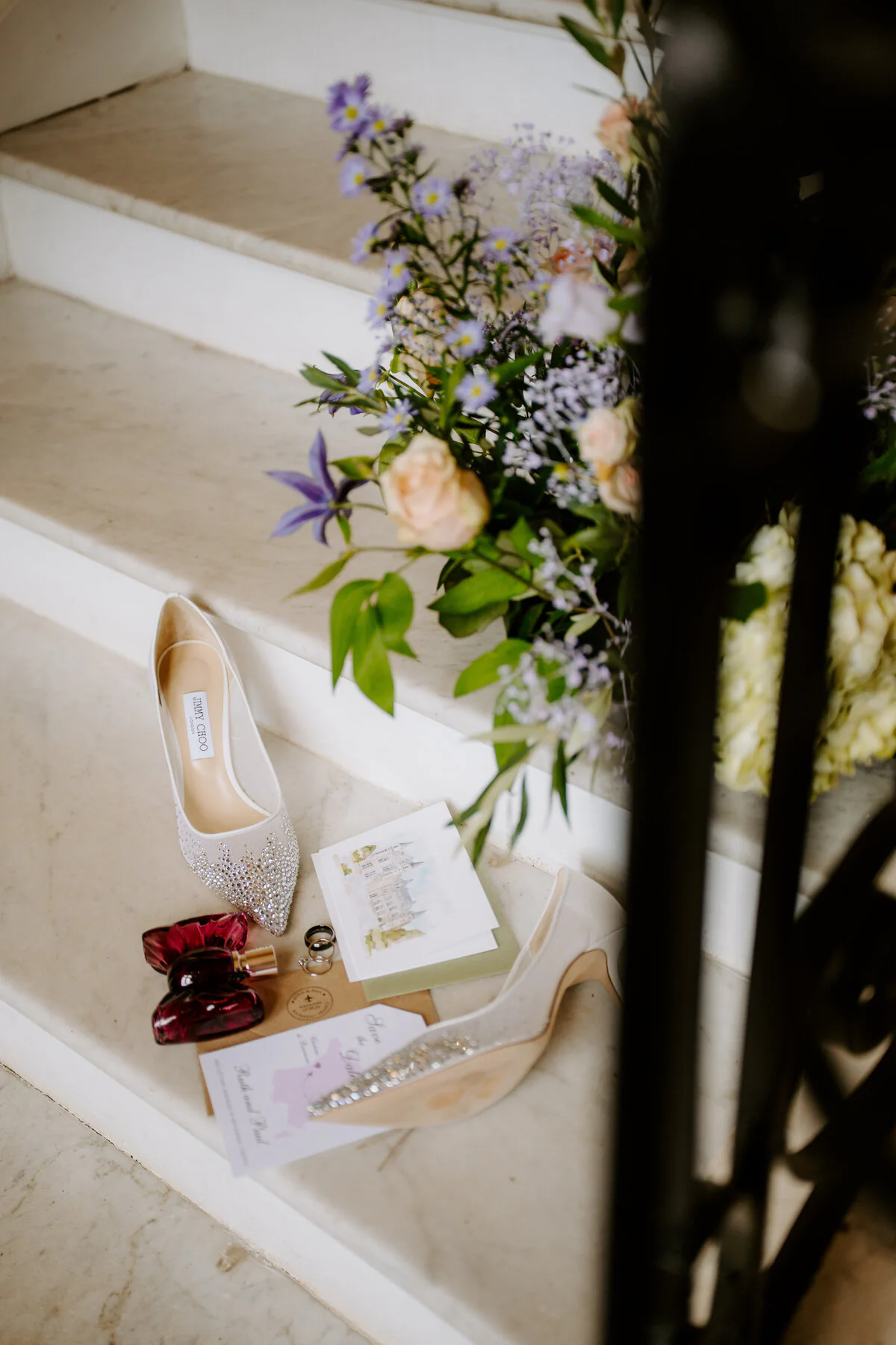 Bridal shoes, flowers and wedding stationery arranged on a staircase.