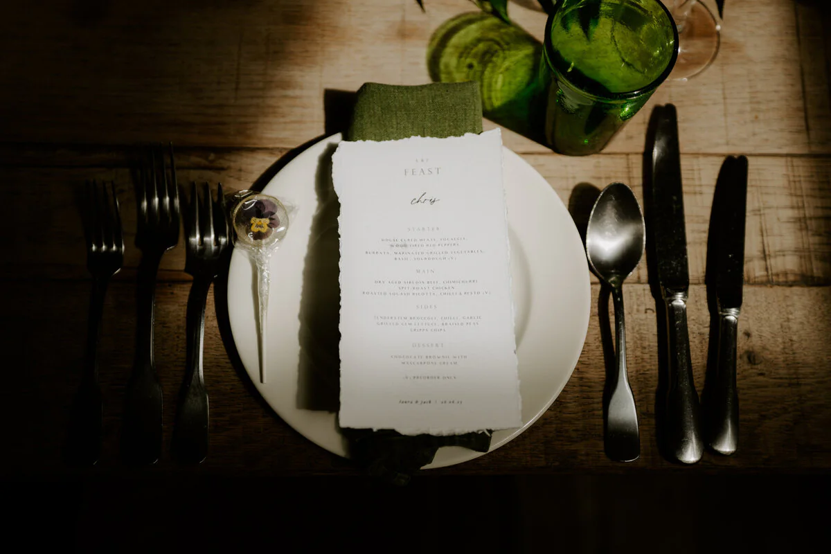 Close-up of a wedding menu on a rustic table setting.