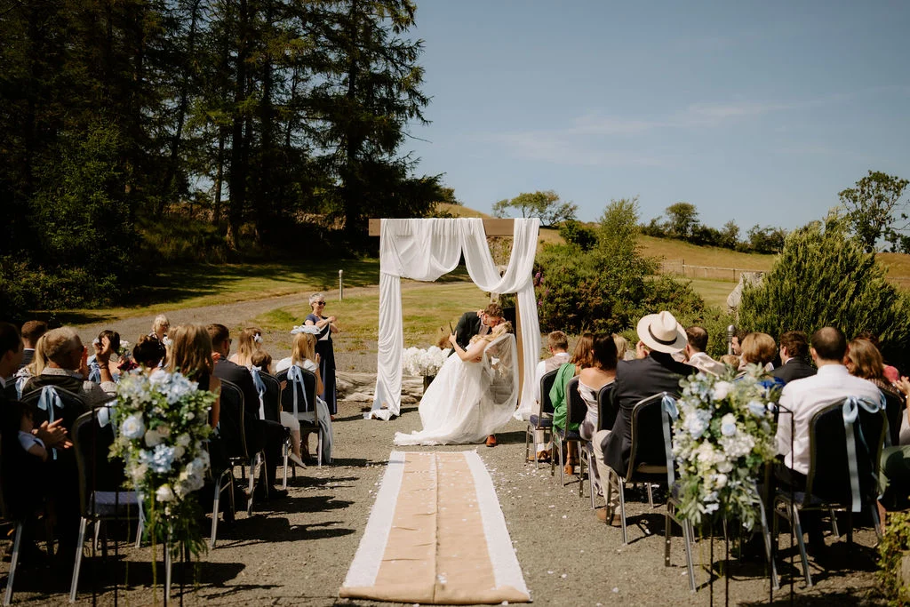 Wide view of guests watching Ella and Josh’s outdoor ceremony