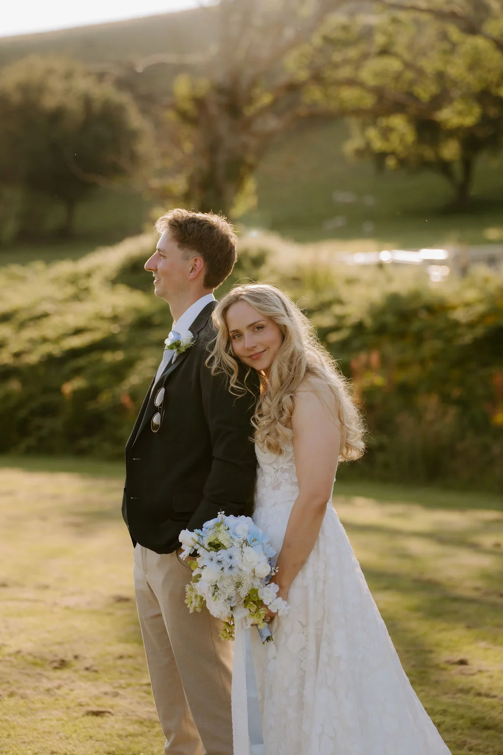 Ella and Josh embracing in golden evening light