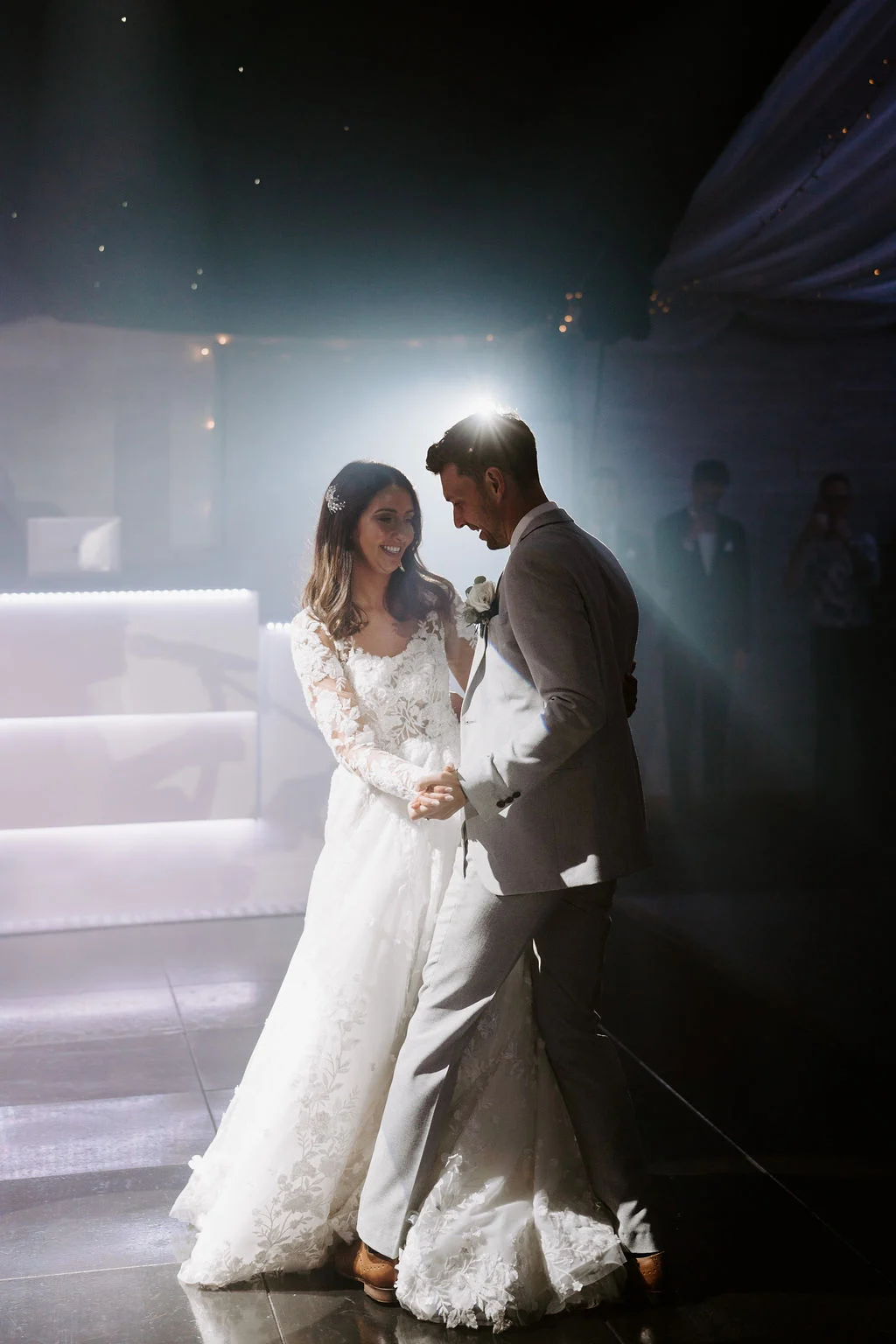 Jenny and Neil together at night beneath a bright outdoor light