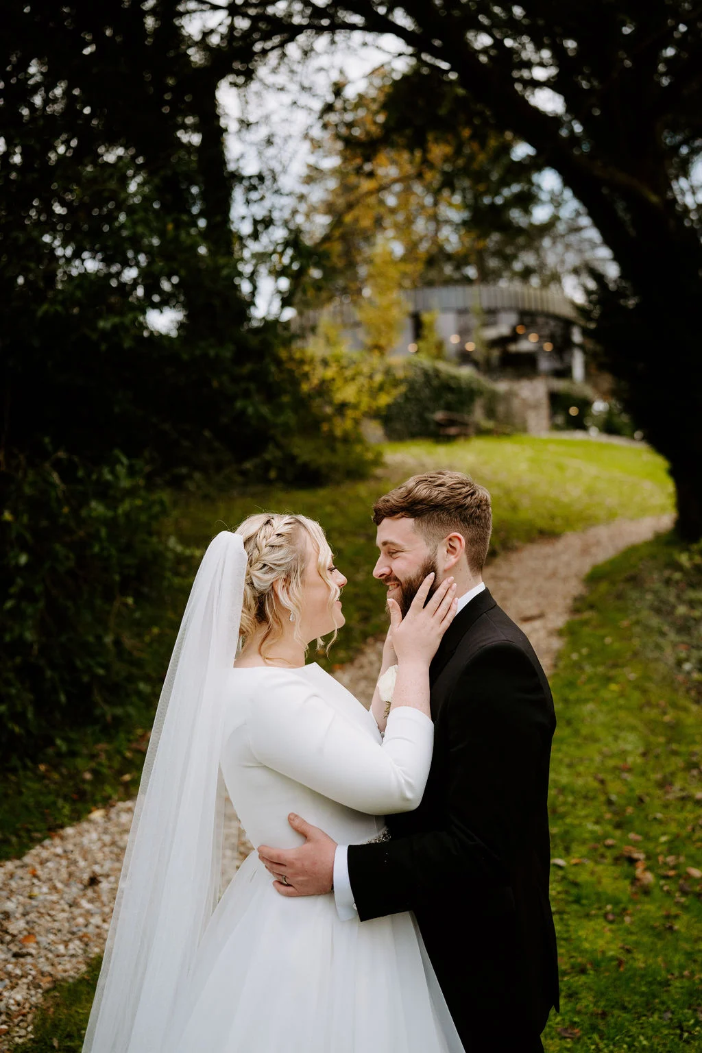 Max and Gwen sharing a kiss in the green gardens at Fairyhill