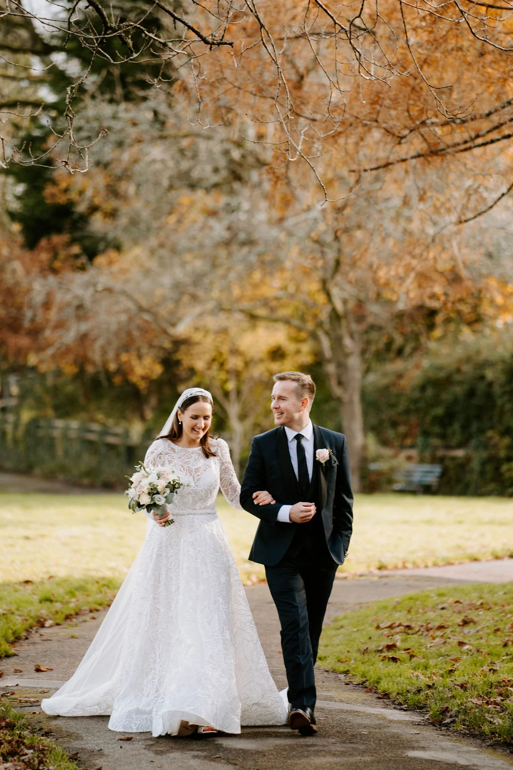 Ruth with two guests beneath colourful autumn trees