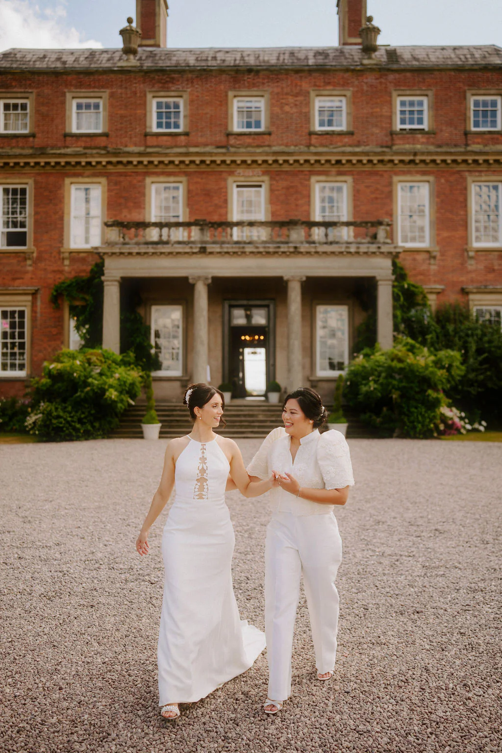 Anna & Emilyn enjoying drinks with guests on the lawn at Davenport House in Shropshire