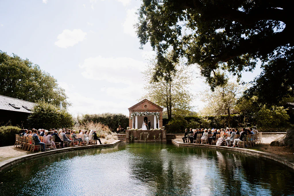 Charlotte & Matt outdoor garden wedding ceremony beneath the ancient trees on the lawn at Pennard House in Shepton Mallet