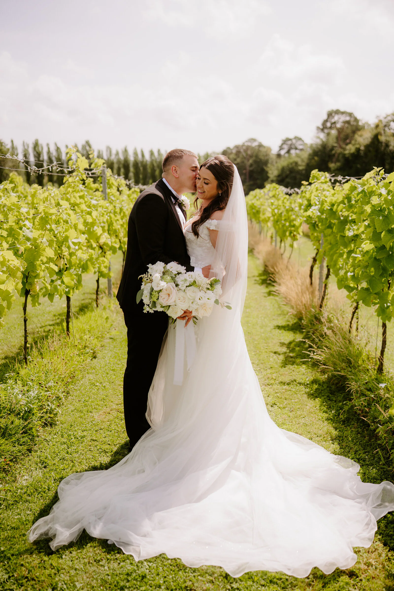 Couple portrait between the vines at Llanerch Vineyard