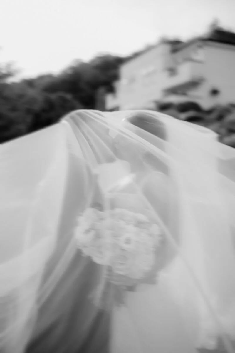 Romantic couple moment beneath the veil at Coed-Y-Mwstwr Hotel