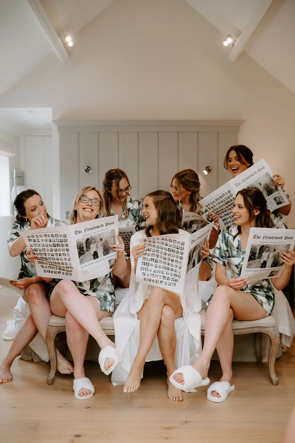 Hannah and her friends laughing together with newspapers during preparations