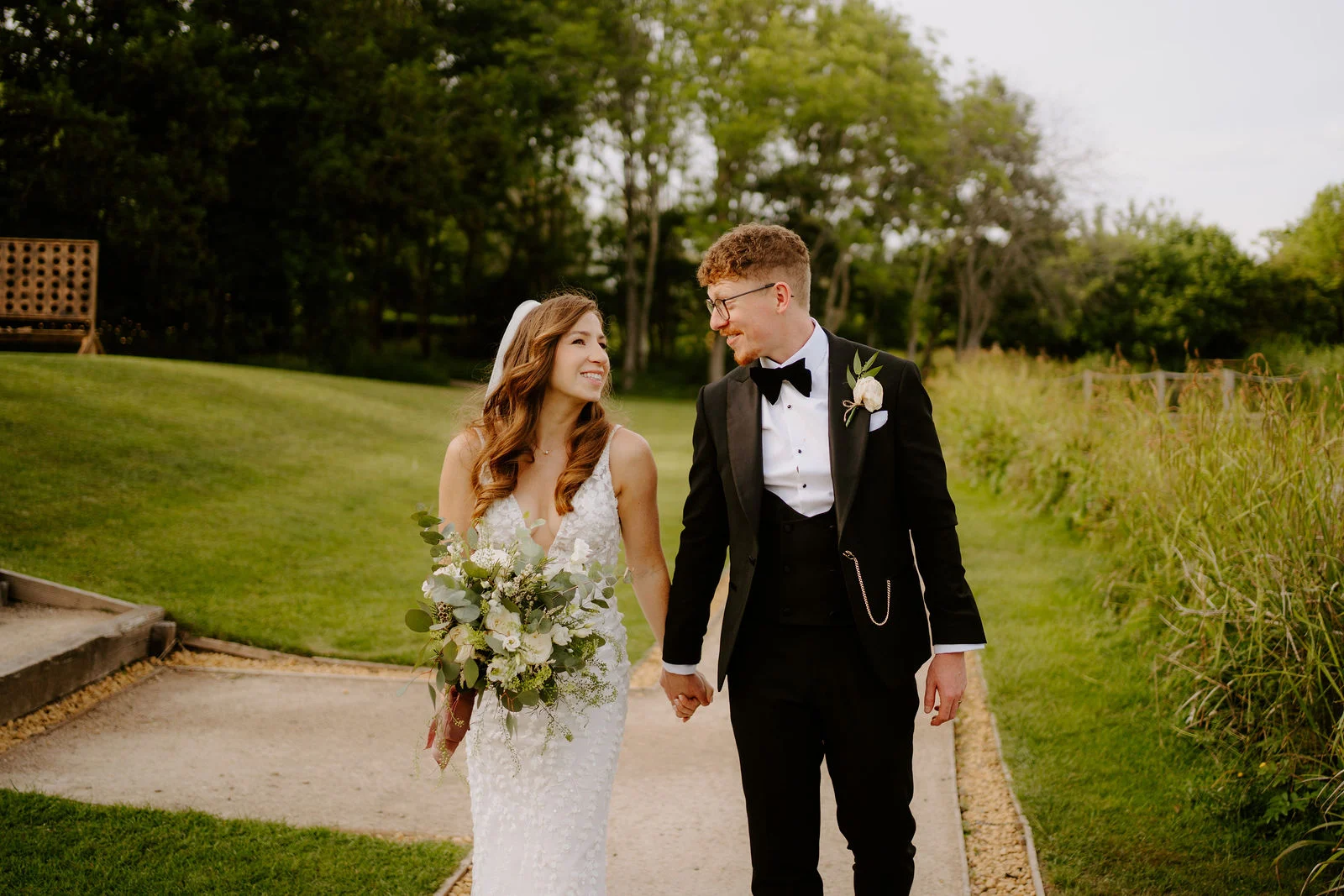 Natalie and Tom walking beside the meadow at Elmbridge Farm