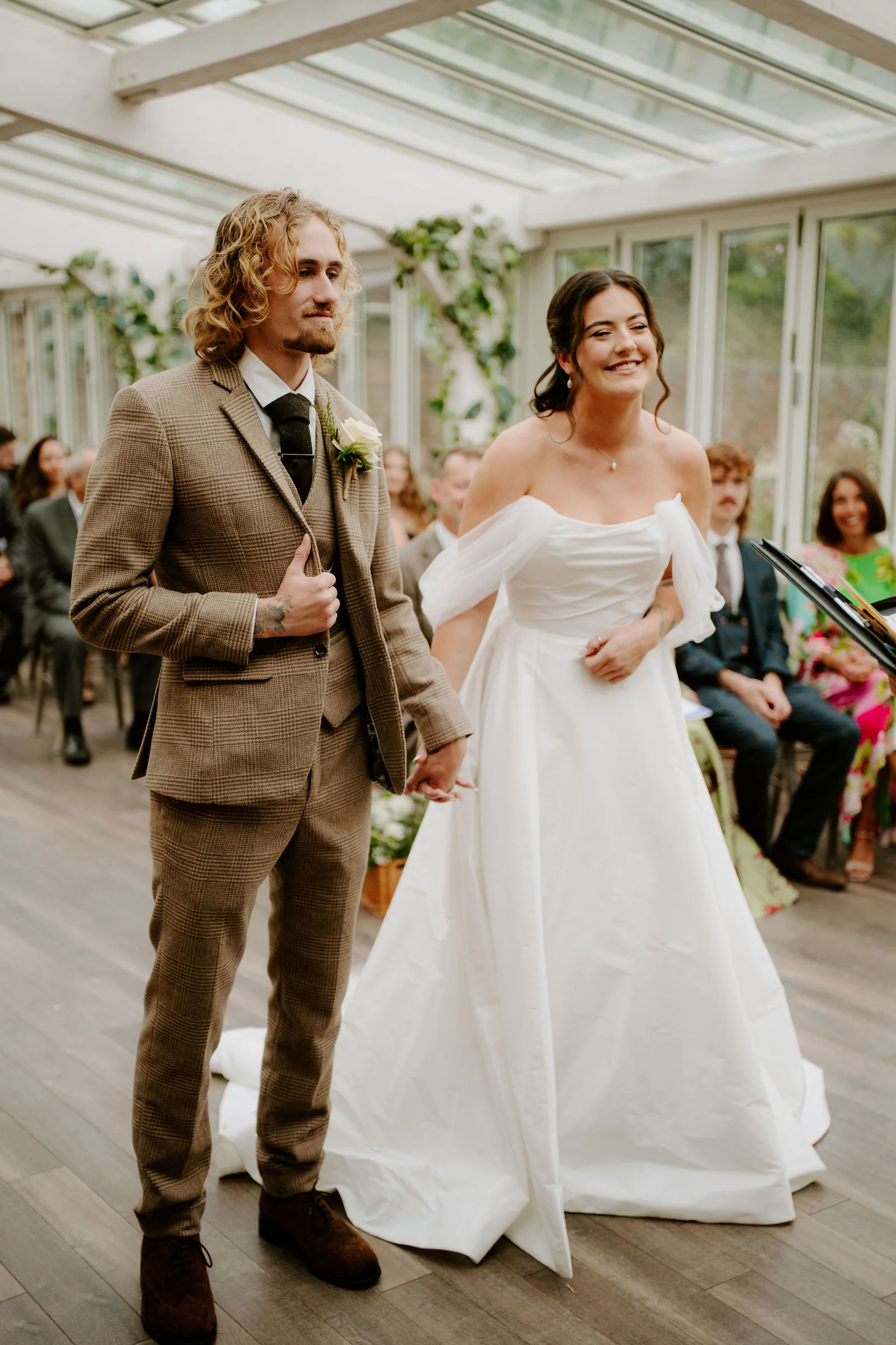 Jenny and Conan together during their ceremony in the glass-roofed room at Foxtail Barns