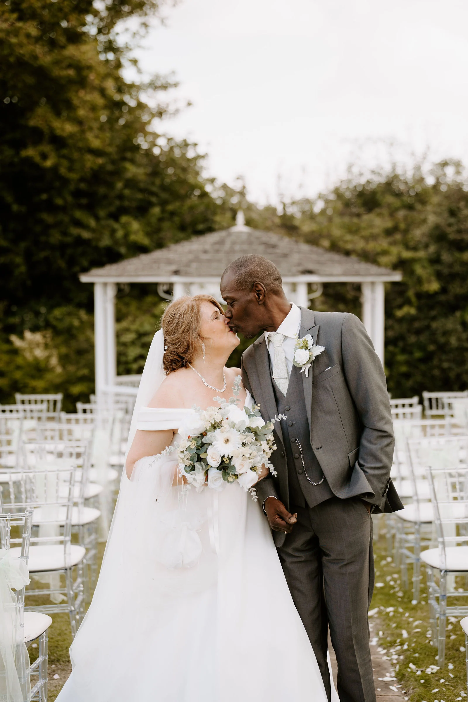 Linda and Alex kissing in front of the garden pagoda at Park Hall Hotel and Spa