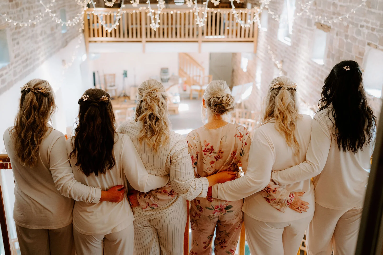 Jolene and her wedding party looking into the decorated barn at The Ashes Barns