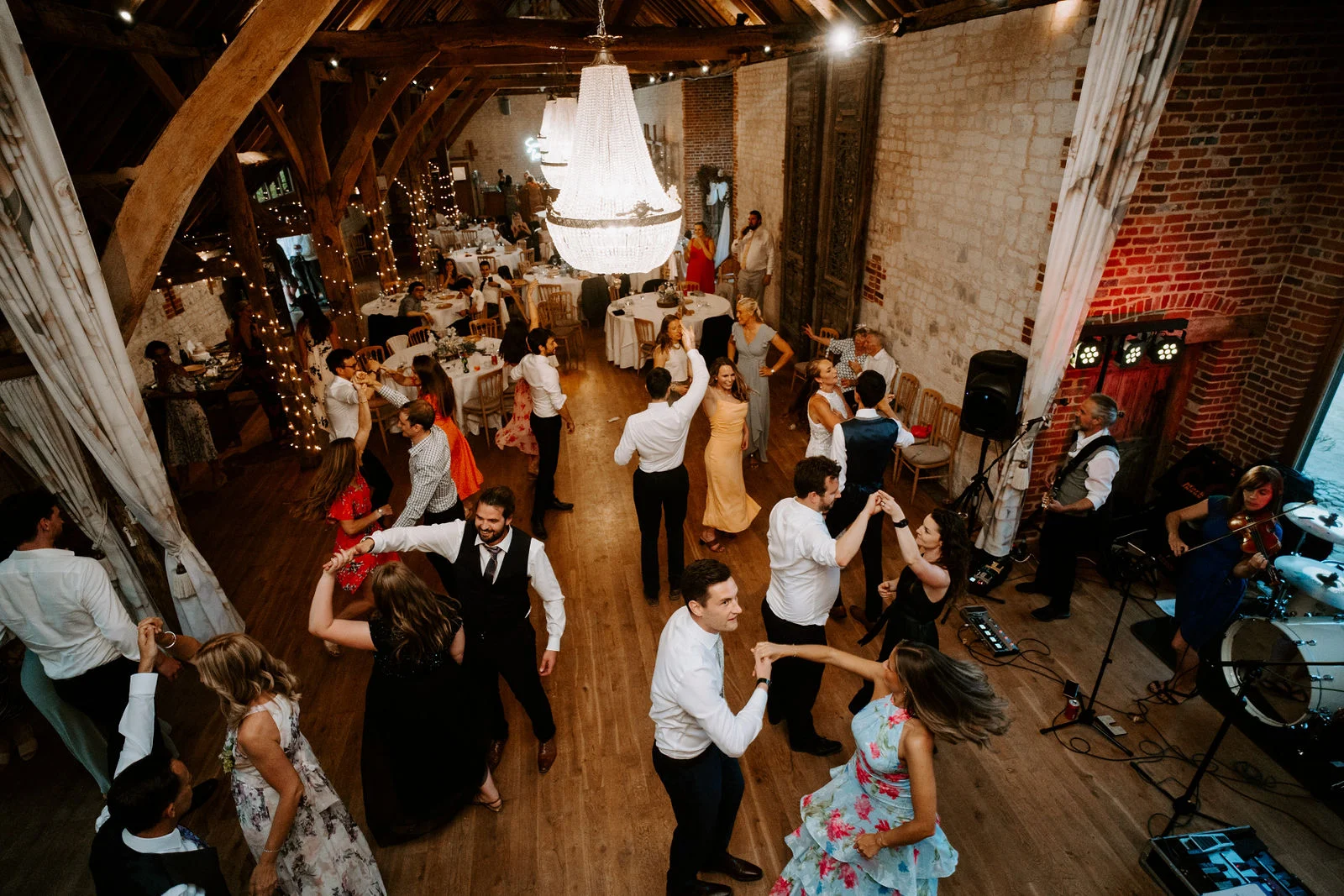 High-energy dance floor celebrations inside the oak barn at Bury Court