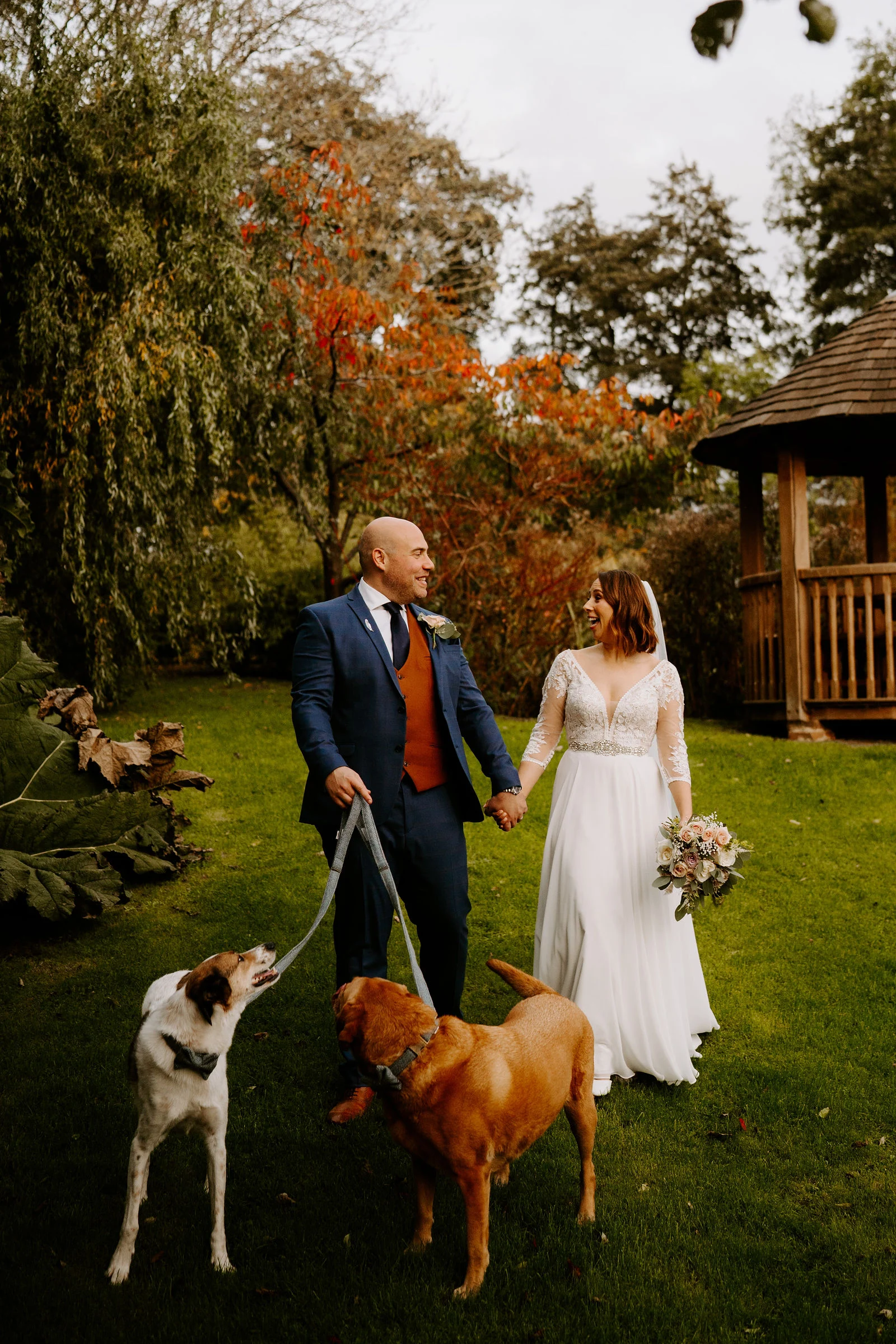 Suzanne and Michael standing on the wooden bridge over the river stream at Coltsford Mill
