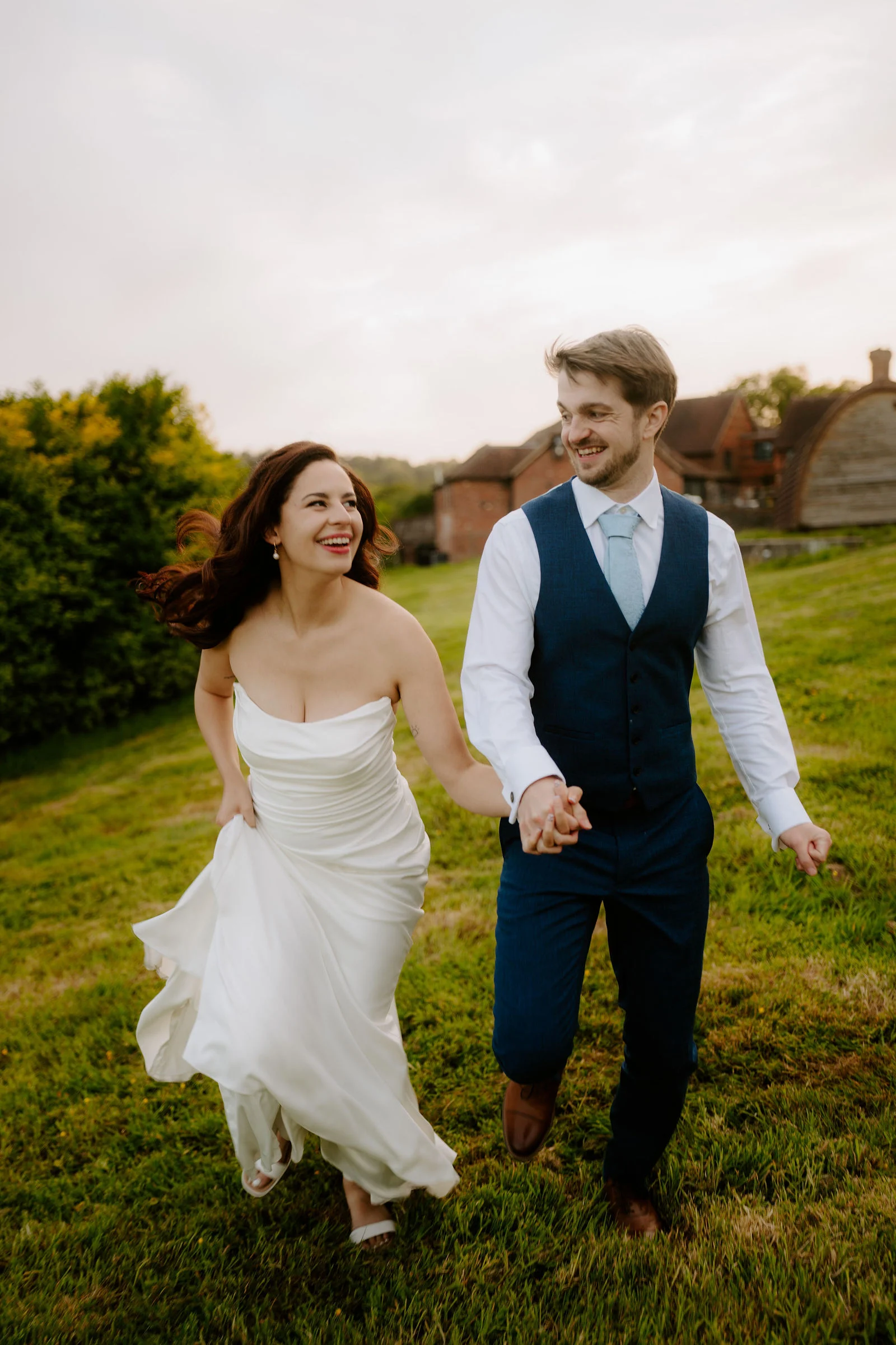 Warm golden hour sunlight bathing Ana and Dan during an evening stroll on the lawns at Lythe Hill Hotel