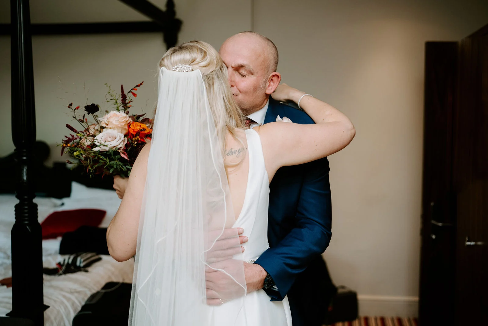 Georgie and Alastair exchanging vows inside the historic Tudor room with exposed oak beams at Lythe Hill Hotel