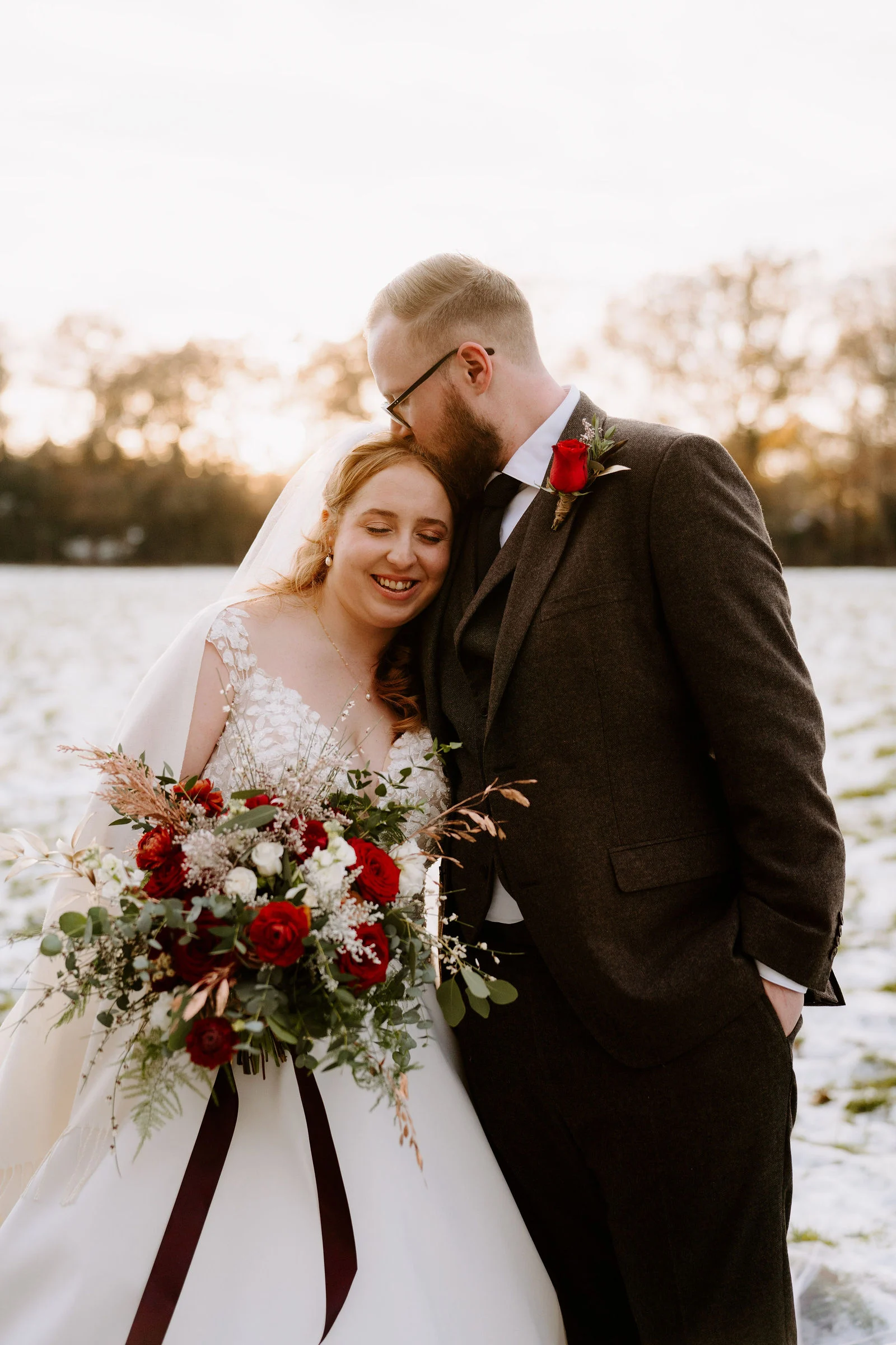 Jonathan and Tiffany sharing an affectionate moment in the woodland clearing outside The Green Barn in Dorking