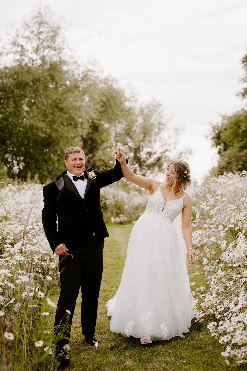 Caitlin & Tom relaxed couple portrait by the thatched stone barn at Blackwell Grange in Warwickshire