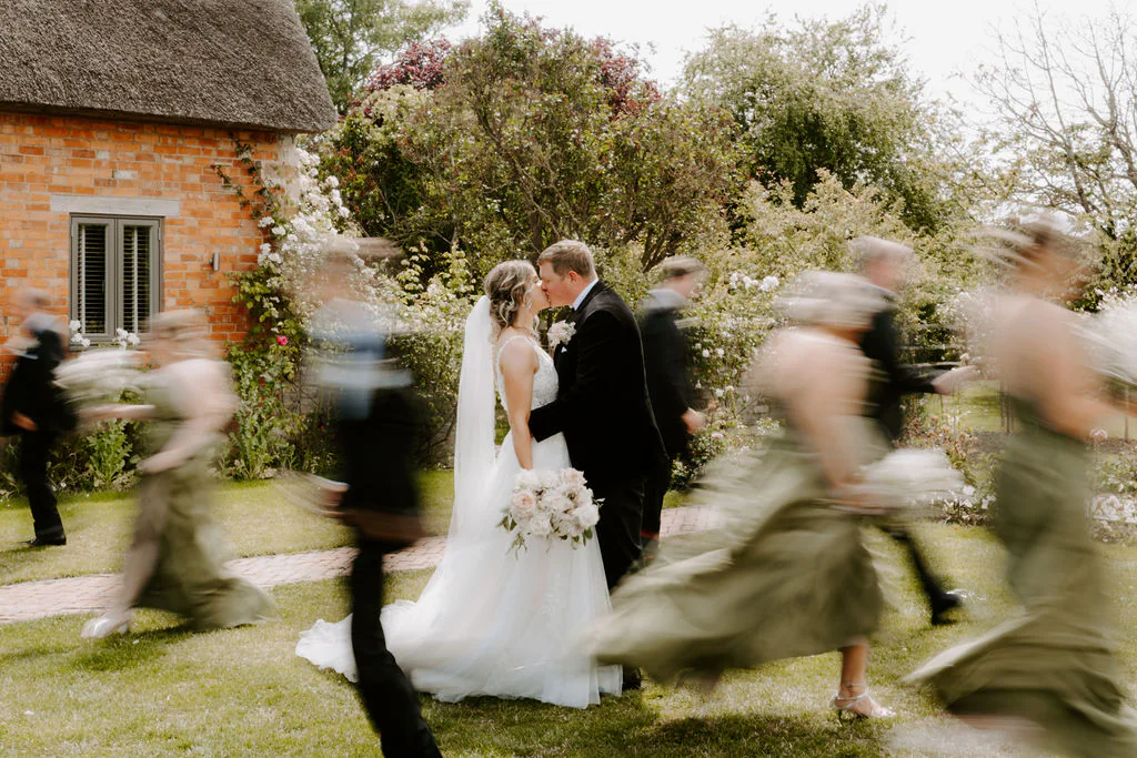 Caitlin & Tom walking across the moonlit lawn at Blackwell Grange during their evening wedding party