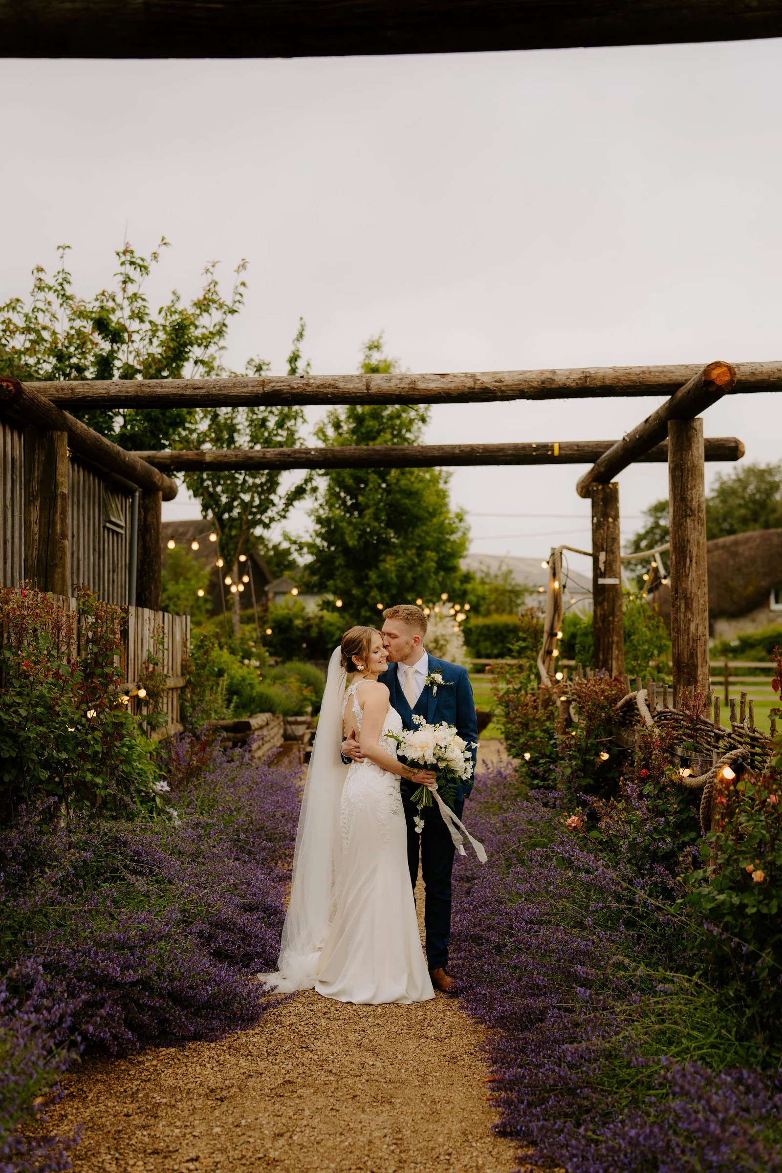 Vanessa and Harvey romantic golden hour embrace in the Wiltshire fields at Bowerchalke Barn