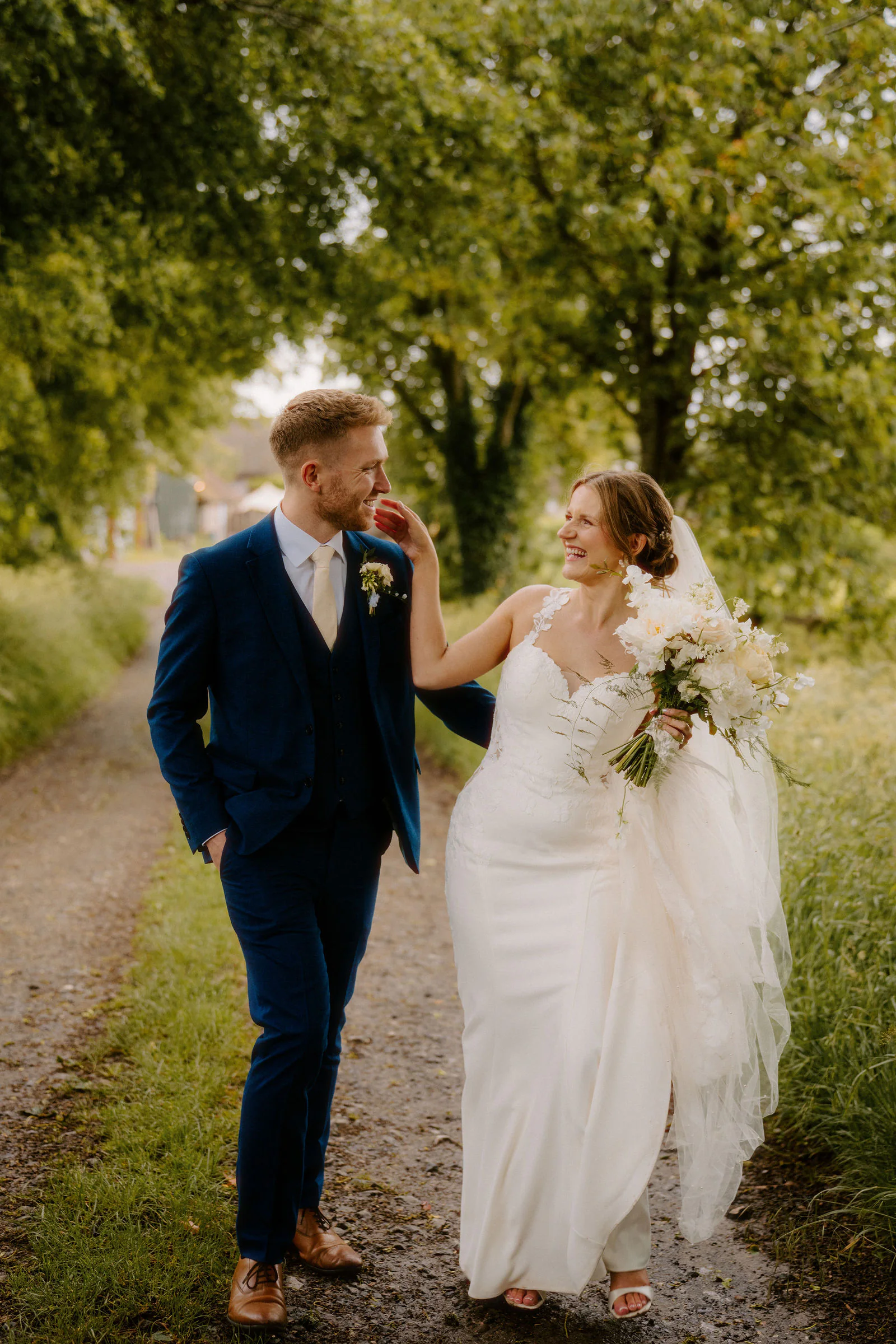 Couple smiling tenderly during their sunset stroll at Bowerchalke Barn in Salisbury