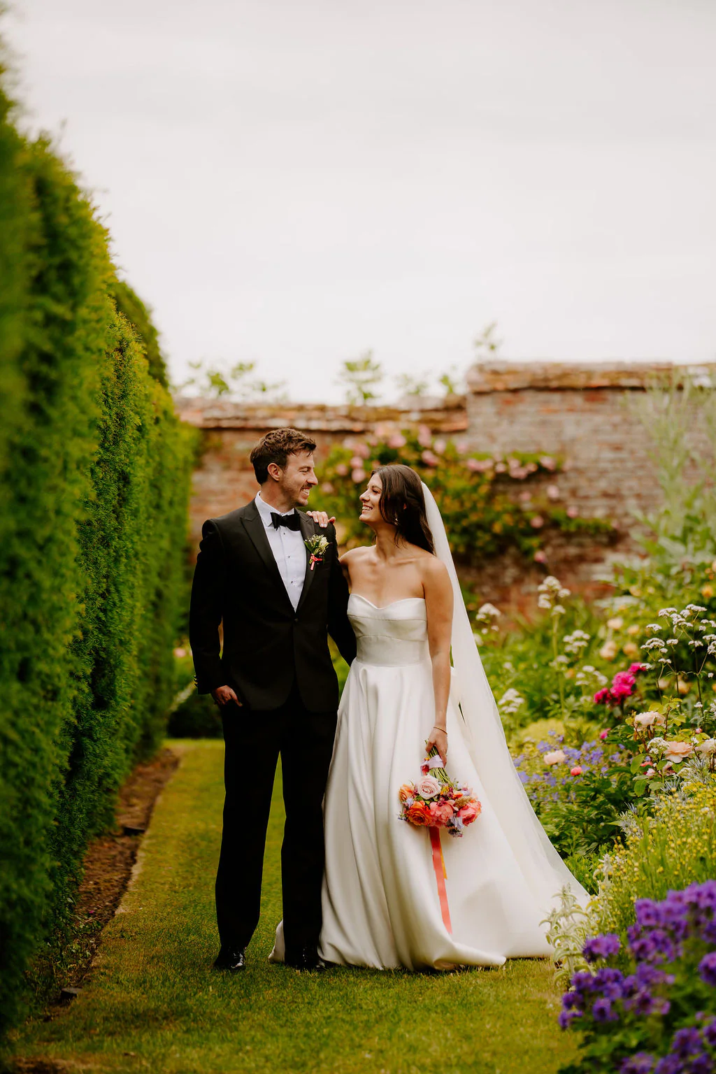 Joyful confetti celebration walk across the bridge at Birtsmorton Court
