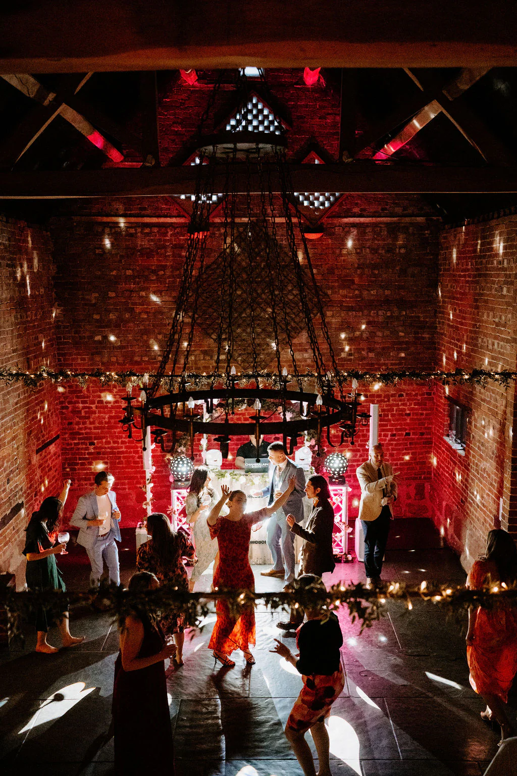 Amy & Matthew smiling together during drinks reception in the courtyard at Curradine Barns