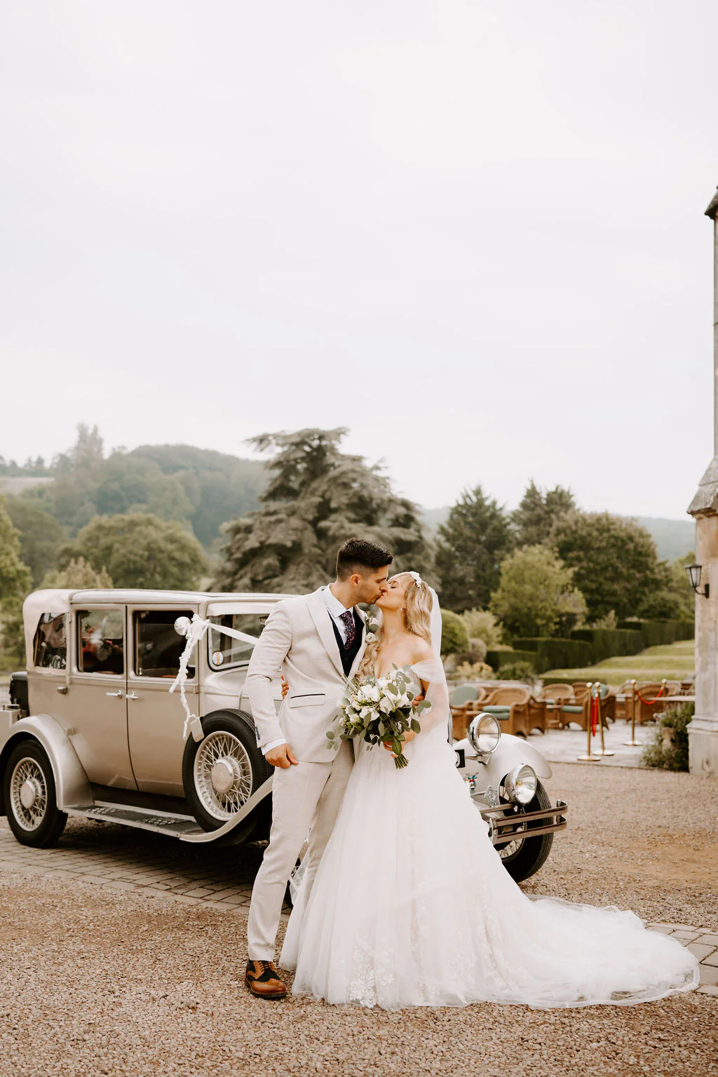 Lucy & Christian confetti celebration outside the 19th-century stone manor at Dumbleton Hall
